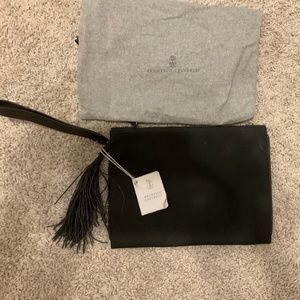 Brunello Cucinelli suede monili trim clutch with tassel and wrist strap.
